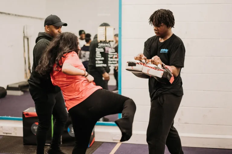A Stride UK coach encouraging a young person during a school sports session